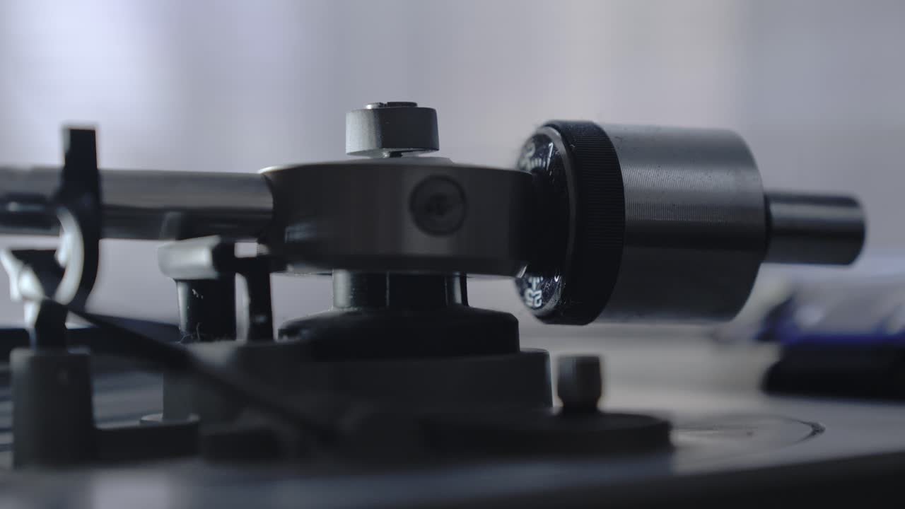 detalle del mecanismo de la mesa giratoria que levanta y guía el brazo de la aguja sobre el disco de vinilo