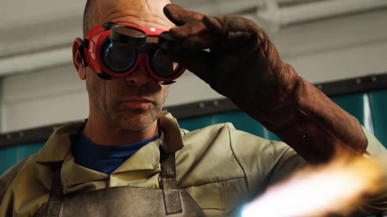 Welder holding welding torch