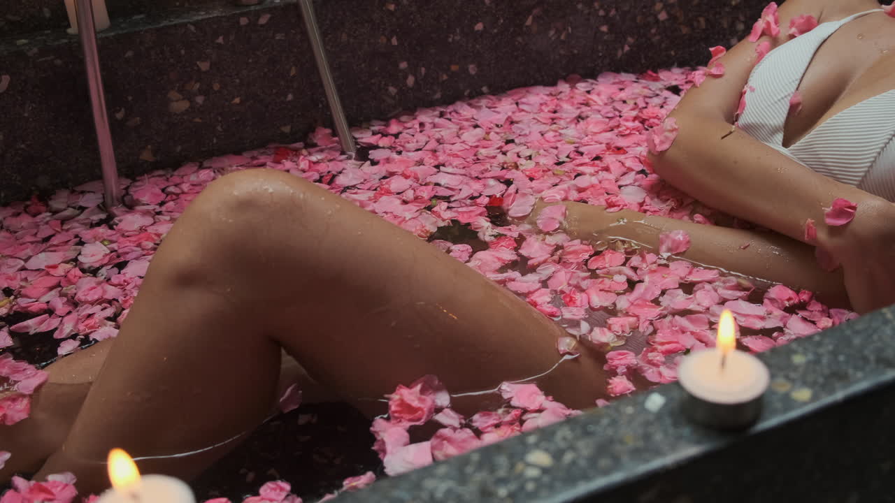 Woman enjoying a rose petal bath