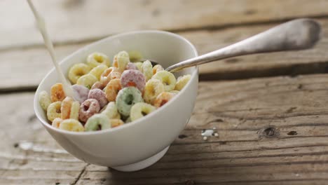 video of cereals in ceramic bowl on wooden kitchen worktop