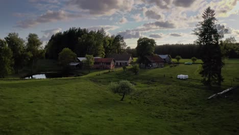 farmhouses and dense forest near countryside village in warmia, poland