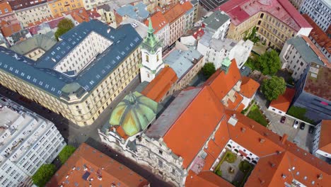 slow aerial descent into urban landscape of brno, czechia