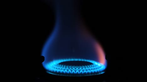 gas stove being turned on isolated on black background. natural gas deficit concept. 4k resolution video