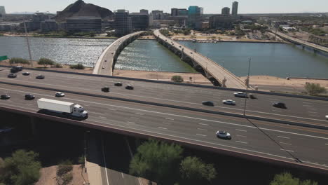 aerial view of highway and bridge over river in a cityscape