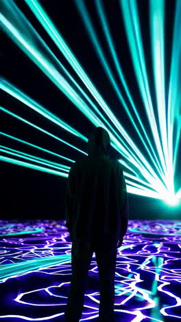 person in hoodie facing radiant neon light trails