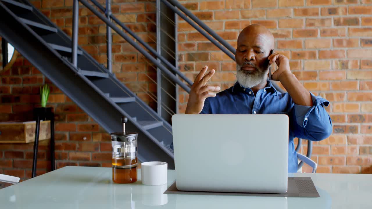 Senior man talking on mobile phone at home 4k