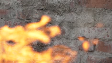 fire flame in slowmotion with brickwall background, shooting with high speed camera