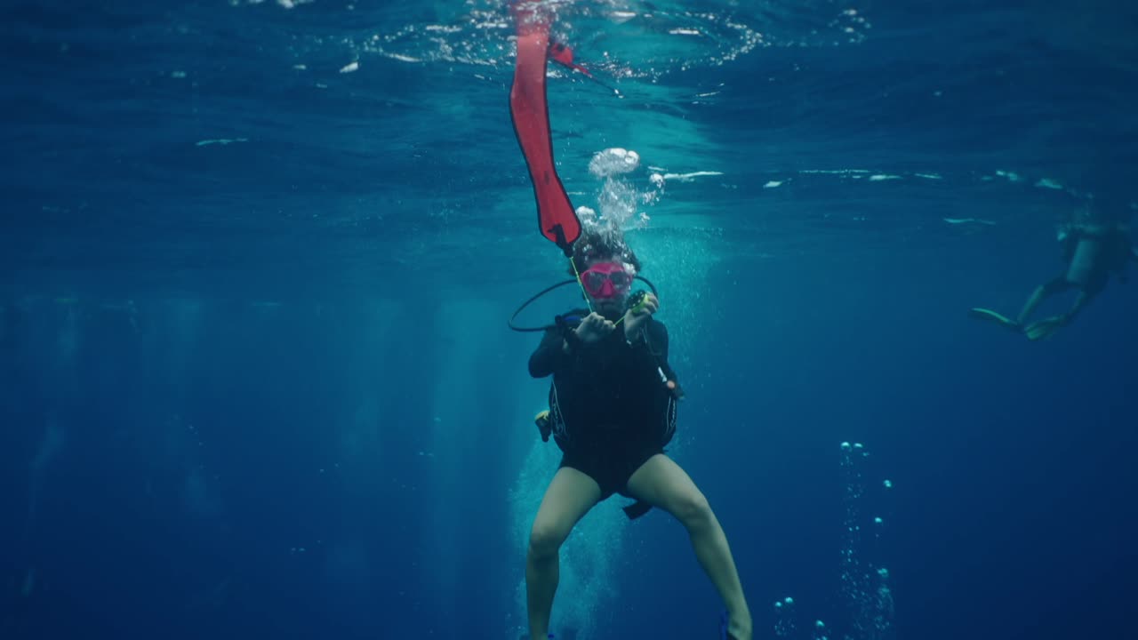 Scuba Diver with Signal Buoy Underwater