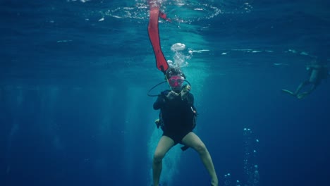 scuba diver with signal buoy underwater