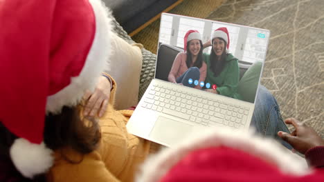 Happy-diverse-couple,-mother-and-daughter-having-christmas-laptop-video-call,-slow-motion