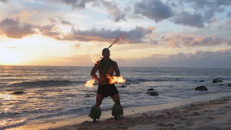Fire-juggler-juggling-fire-sticks-in-the-beach-4k
