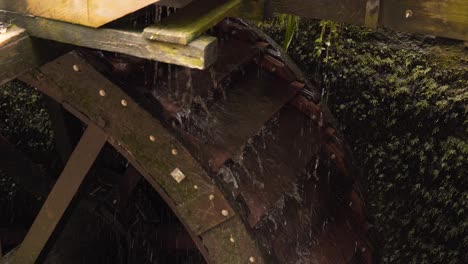 close up on a section of a wooden water wheel from a water mill