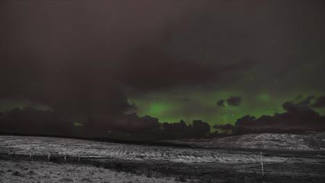 time lapse of the aurora borealis on a snowy night