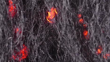 abstract texture of wire fibers with blurry fire in background of burning steel wool