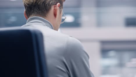 office 360 degree: portrait of creative businessman sitting at his desk using smartphone. digital entrepreneur using mobile phone, internet e-commerce online shopping. tracking moving around shot