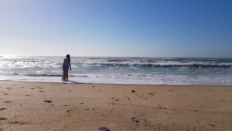 mother and daughter is having fun on the beach