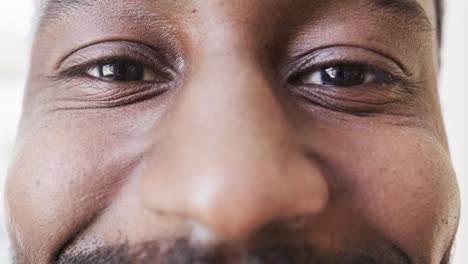 portrait close up of eyes of happy african american man smiling, in slow motion, copy space