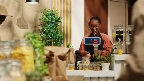 merchant placing all produce on electronic scale at checkout