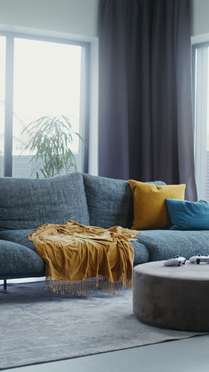 Older man playing video game on couch