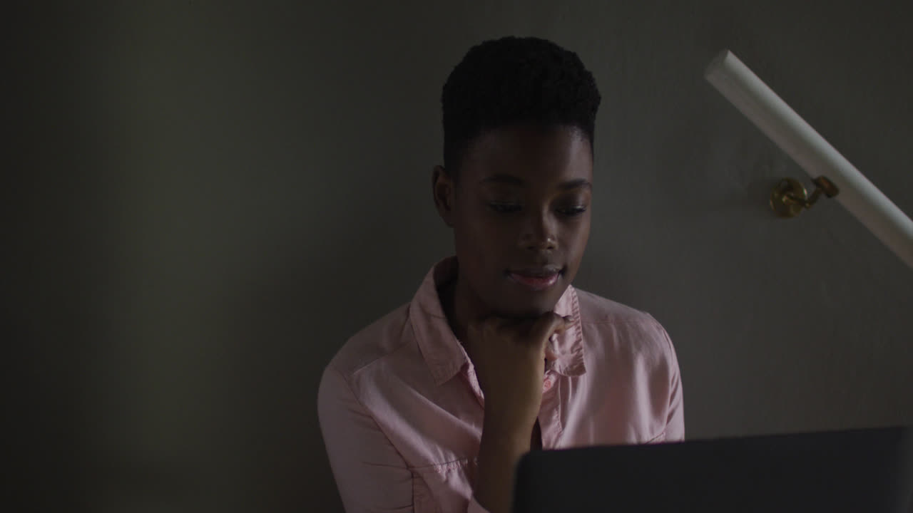 African american woman using laptop while working from home