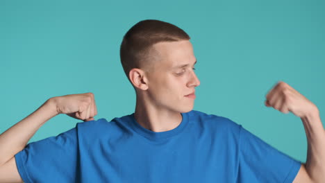 happy young man posing and showing muscles