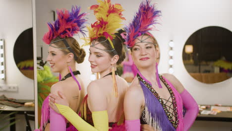 three girls posing in the backstage