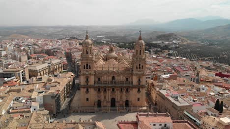 Spain-Jaen-Cathedral,-Catedral-de-Jaen,-flying-shoots-of-this-old-church-with-a-drone-at-4k-24fps-using-a-ND-filter-also-it-can-be-seen-the-old-town-of-Jaen