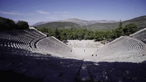 the historical theatre of ancient greece in athens on a sunny day - high angle panning shot