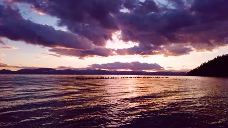 Gorgeous-aerial-over-Lake-Tahoe-at-sunset-with-abandoned-pier-pilings-at-Glenbrook-Nevada