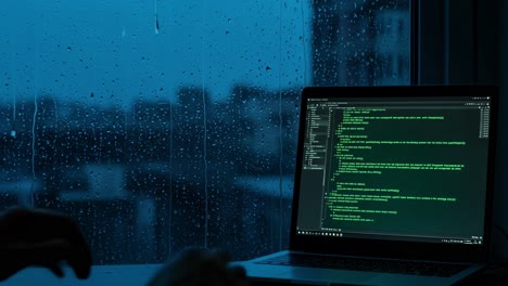 as rain softly falls outside my urban apartment, i find myself coding while the vibrant city lights twinkle in the background