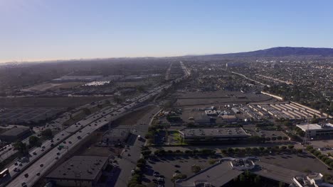 aerial shot flying over the 110 freeway with long beach in the far distance