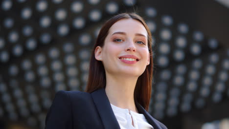 business woman posing camera outdoors. beautiful girl looking around outside.