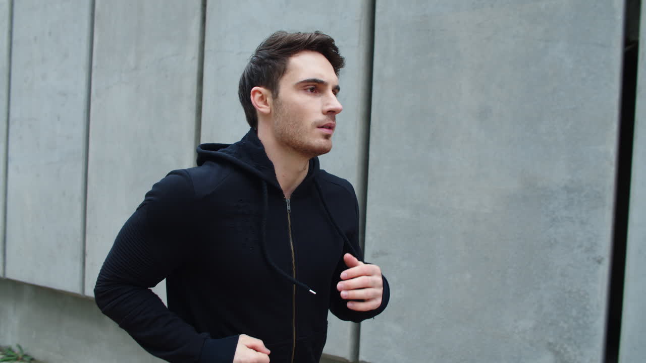 un chico guapo corriendo por las escaleras en cámara lenta.