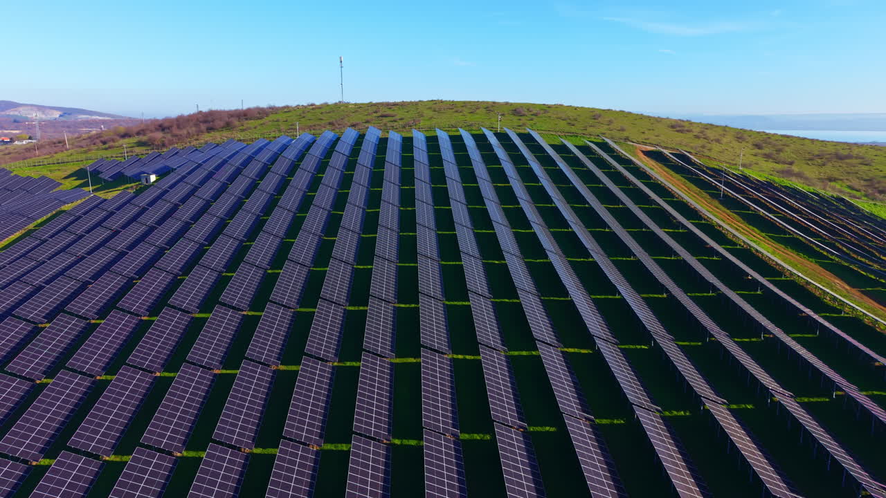 Vast solar panel array harnesses sun's energy on a sunny hillside in early spring, showcasing sustainable technology in harmony with nature