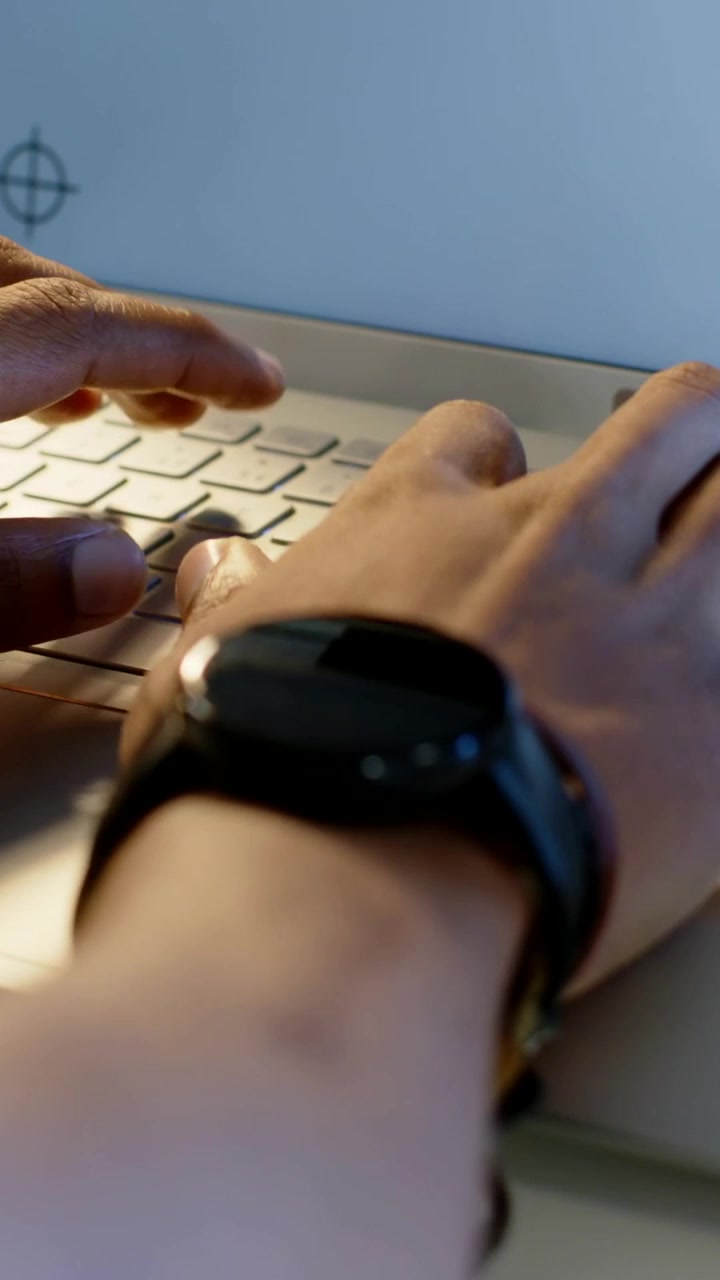 Vertical video: Finishing notes, man lifting pen, reaching for laptop and typing at desk for work