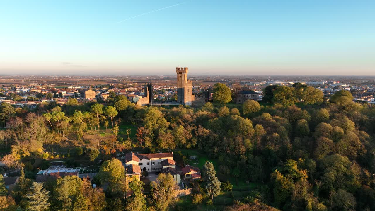 Aerial Bottom up Backward Drone shot of Valeggio's Castle at Golden Hour