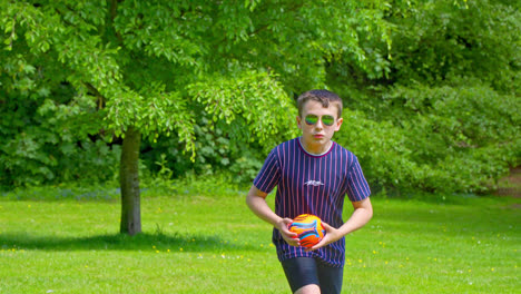 in a uk summer park, a young boy walks and plays, while others delight in the meandering stream, inviting picnics, and hubbard's hills' wooded attraction