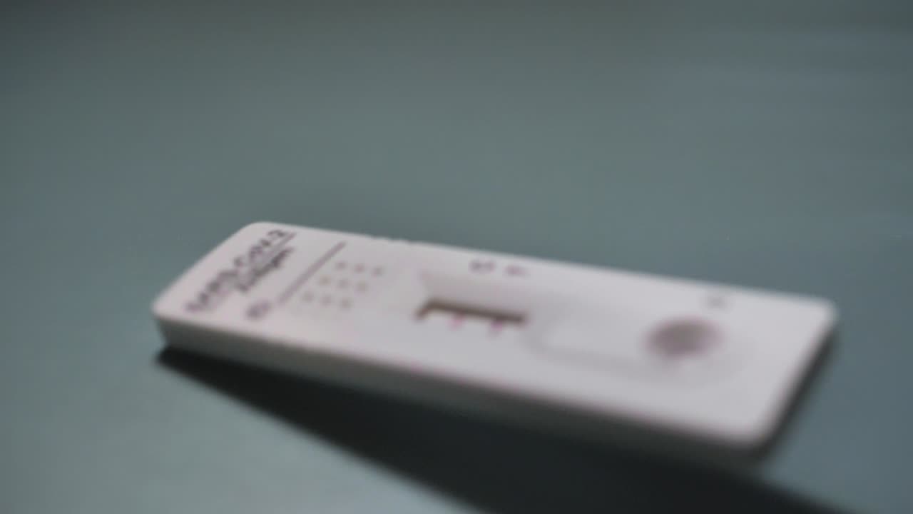 Covid rapid antigen test positive result. Infection, screening and treatment. Slowmotion. Scene C