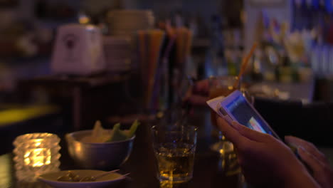 tablet in hands and bar counter