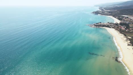 4k slow motion drone clip flying sideways high over a tropical beach in greece