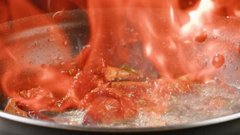 flaming mushrooms in a pan