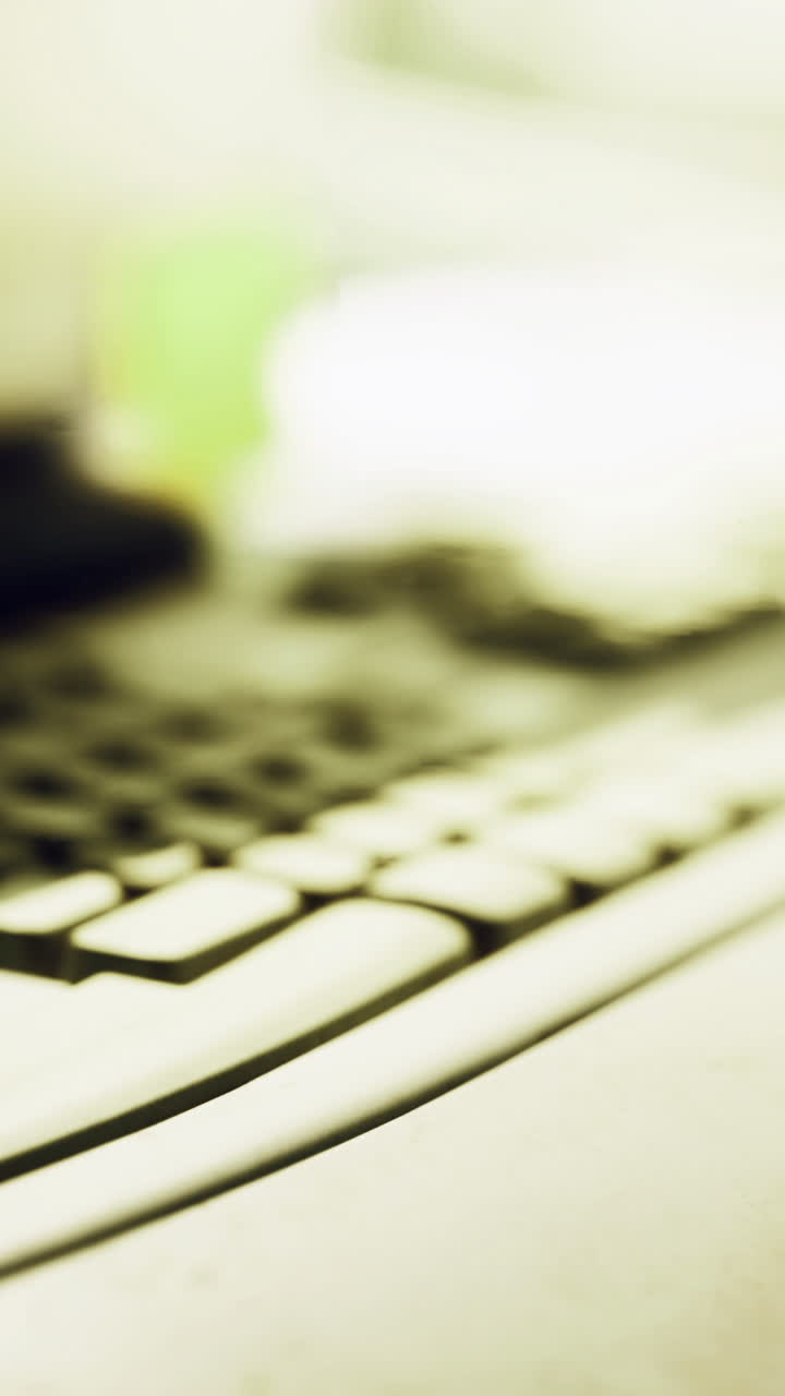 Keyboard and workspace setup highlighting technology in a dimly lit environment