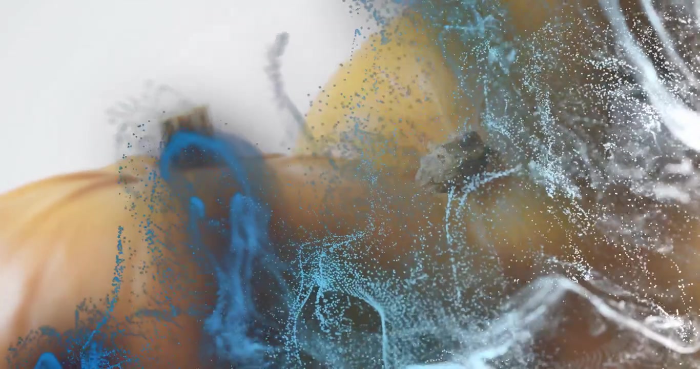 Swirling blue and white particles driving orange sphere emerging while wrapping and revealing form