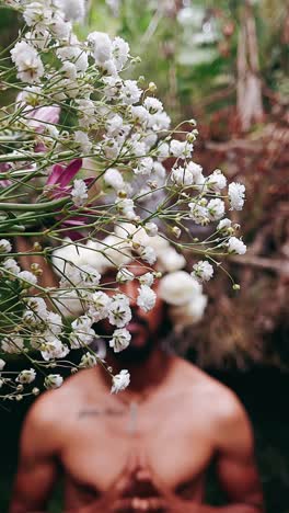 man surrounded by flowers