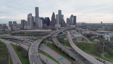 aerial view of traffic on freeway near downtown houston on a cloudy day during sunset