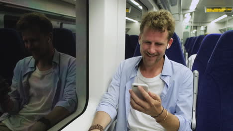 man using smartphone on train