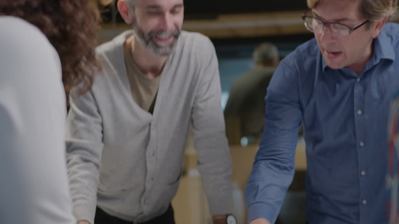 Senior Coworkers Discussing Color Palettes and Floor Plans