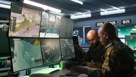 army officers doing brainstorming in command center, looking at intel