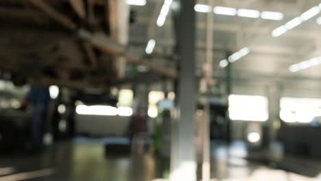 blurred interior view of a busy car repair shop