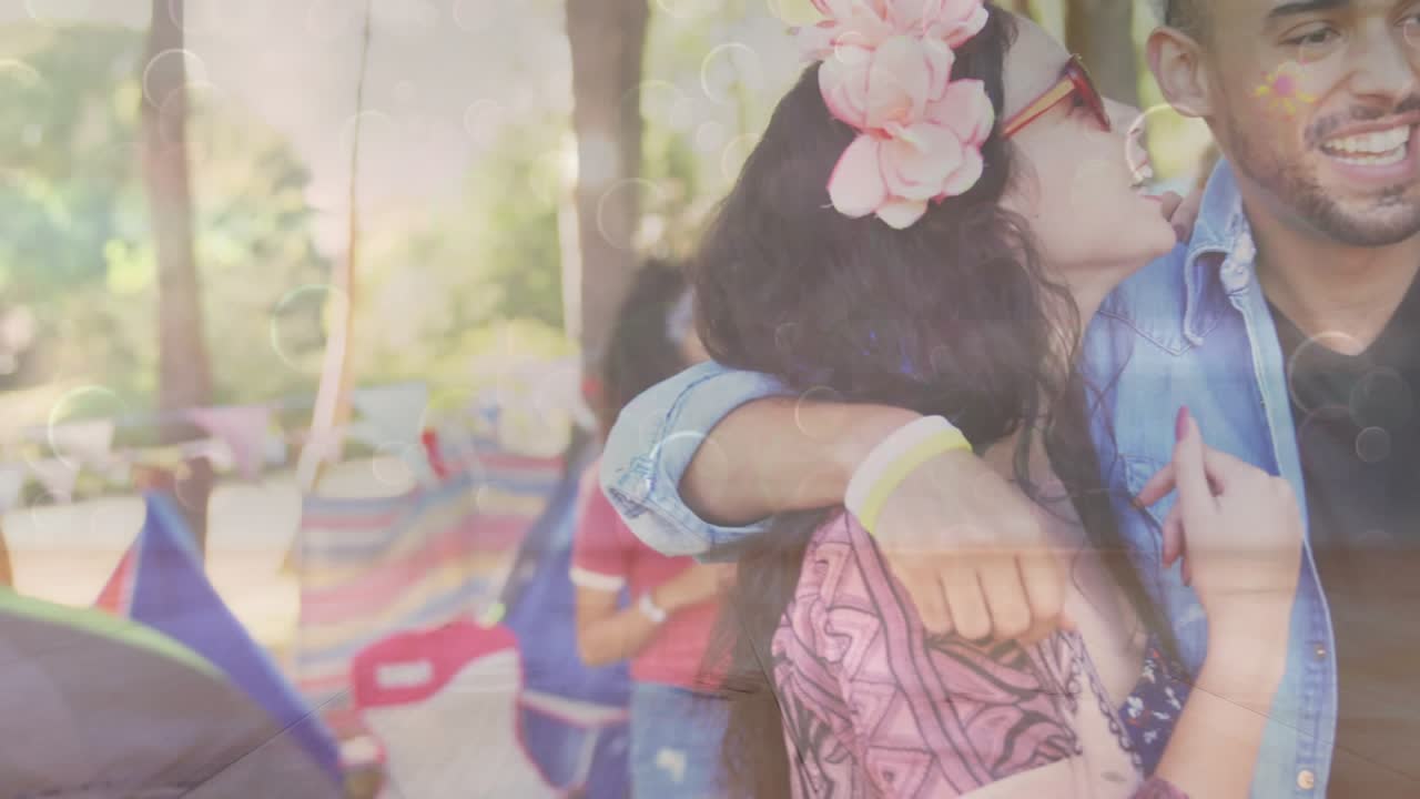 Three friends leaning in exchanging kisses celebrating at festival, animated bokeh touching faces